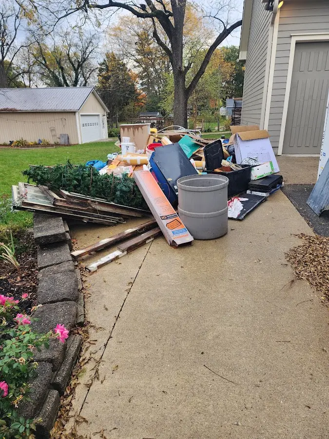 Dumpster being loaded with debris for Roofing Dumpster Rental in Sun Valley